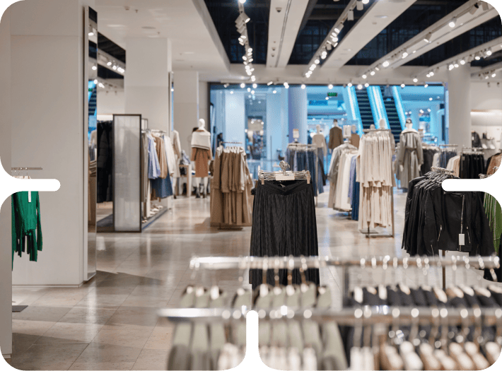 Modern fashion retail store interior with clothing racks and mannequins displaying contemporary apparel business inventory.
