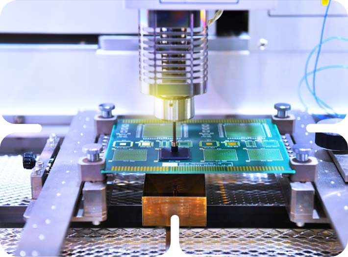 Automated pick-and-place machine manufacturing a green PCB assembly during the ESDM electronics production process.