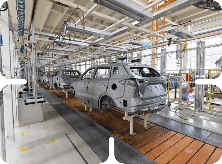 Car bodies on an automated automotive assembly line showcasing advanced product development in a manufacturing plant