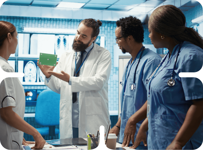 Medical team reviewing smart change enablement tech card in a hospital laboratory setting.