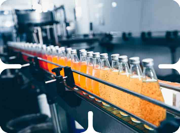 Bottles of juice on an automated factory line demonstrating strategic model alignment in production.
